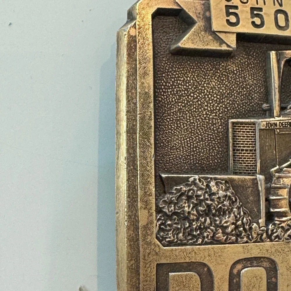 John Deere vintage brass